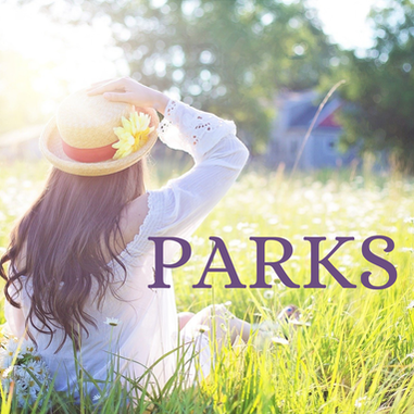 Picture of woman sitting in grass with sun on her with the word park