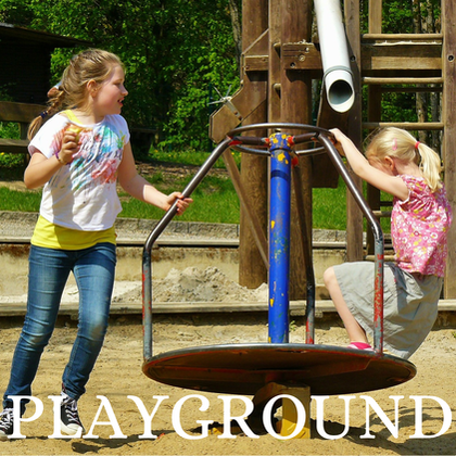 Picture of two kids playing on sit and spin with the word playground