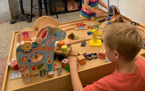 Children playing with toy table at Post Commons in Alton, IL