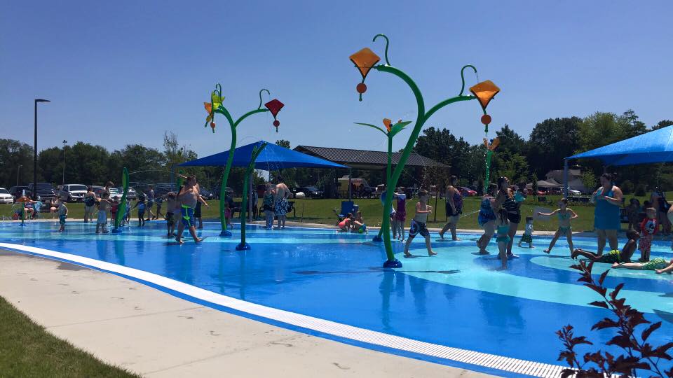 Toddler playing with snake water toy at Alton Splash Pad, photo courtesy of Madison County Kids
