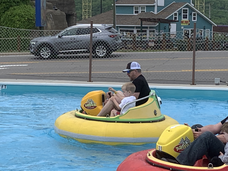 Man and Boy in bumper cars in water in Branson, IL.