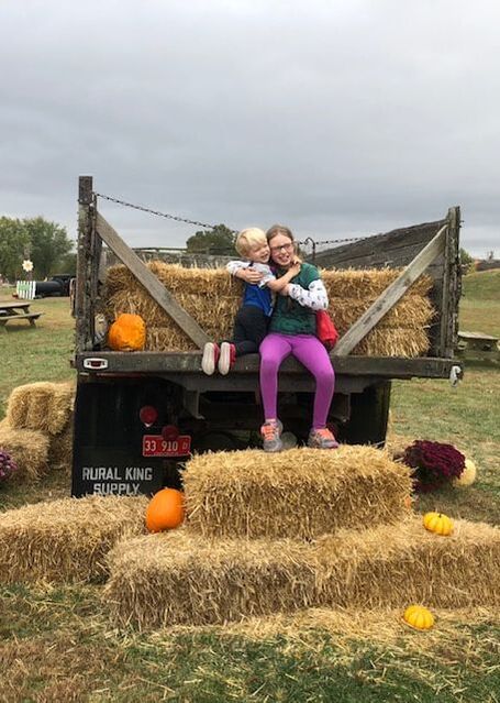 Kids posed by hay bail at Boonies Farm in Worden, IL